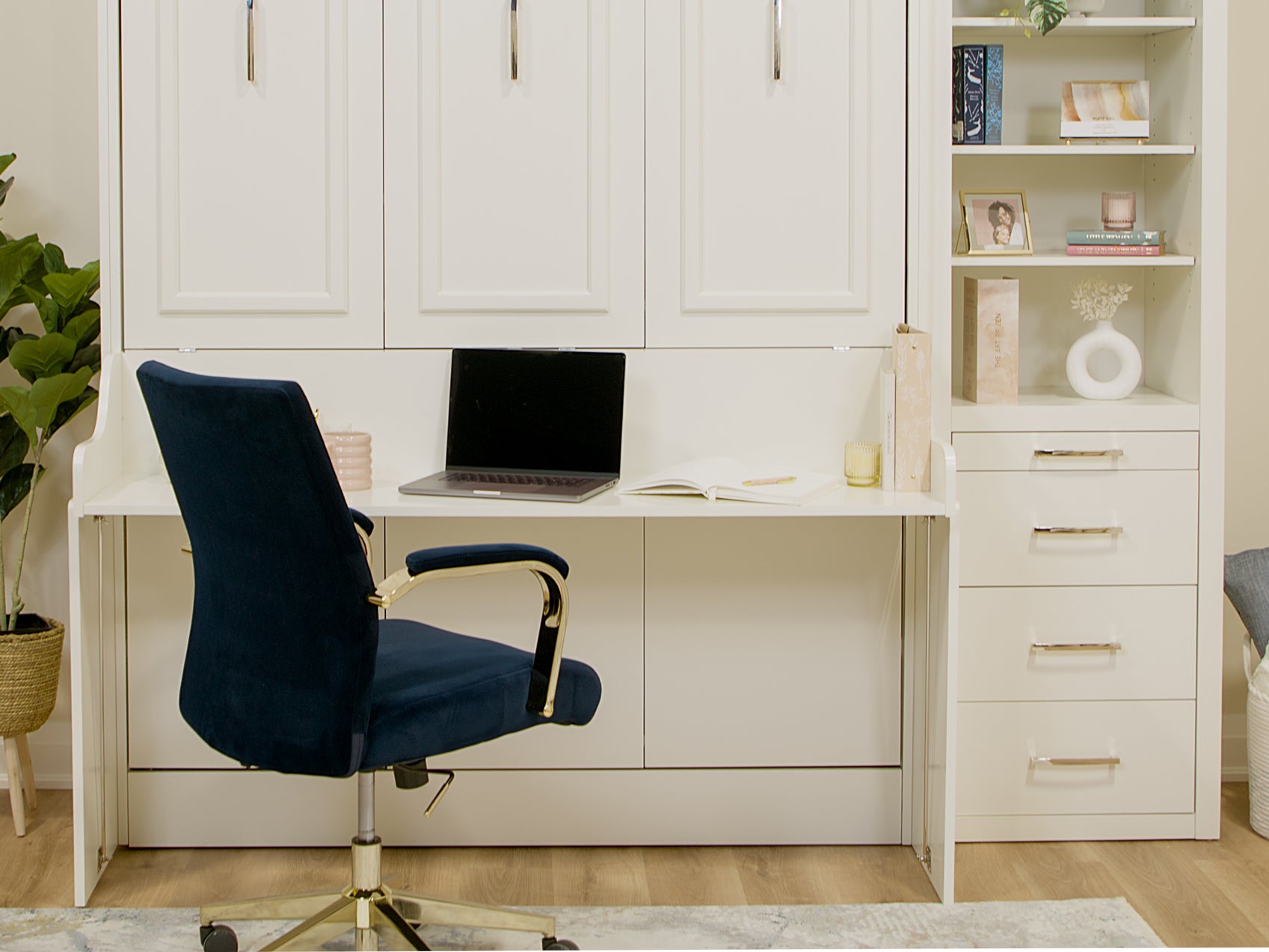 Azore Queen Murphy Bed with self-leveling desk with the bed closed showing a laptop computer, headphones, coffee, etc