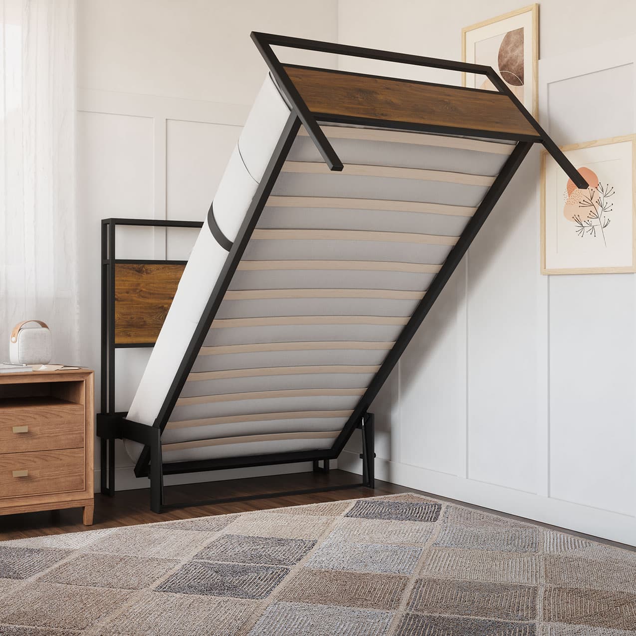 Foldable bed in a room with a nightstand and framed pictures on the wall.