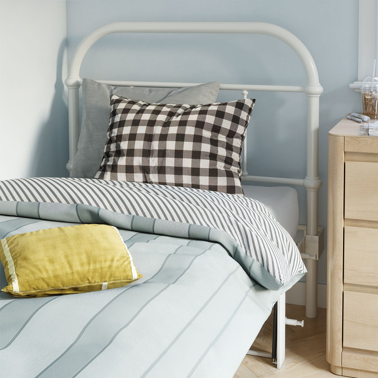 Bed with striped bedding and checkered pillow, wooden nightstand in a bedroom.
bed frame with headboard footboard lift bed storage lift up bedroom furniture risers space-saving black metal