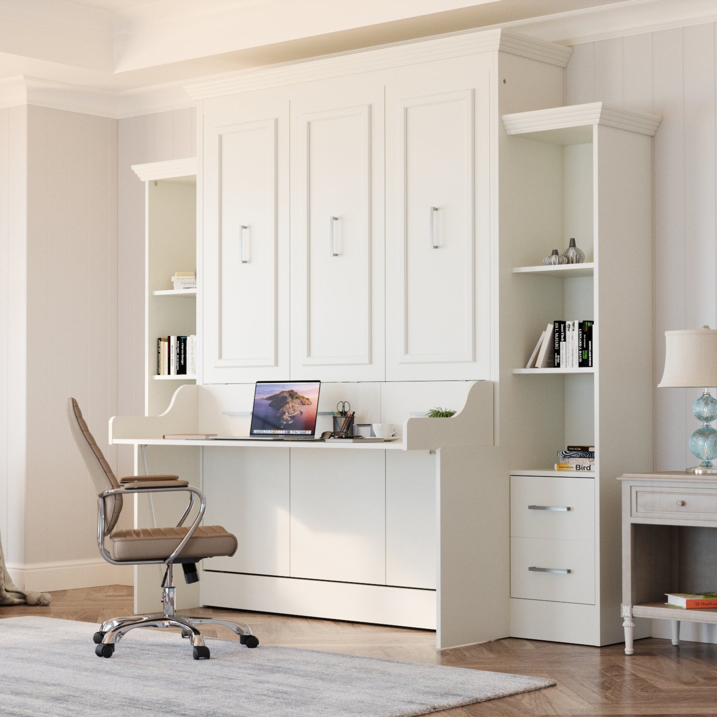 A large white Murphy bed with a desk and integrated storage cabinets on the sides and a brown swivel office chair in a bright room with wood flooring and a light rug.