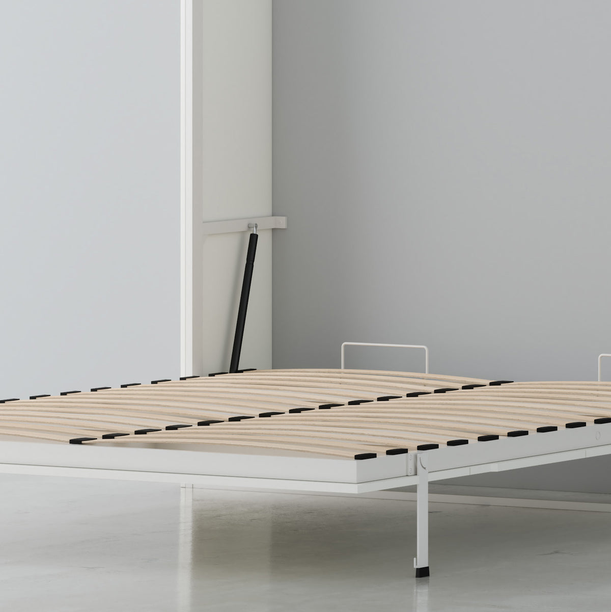 A minimalist Murphy bed  with a white metal frame, light wood mattress support slats, and a 2 piston dual-stage hydraulic lift system, shown in a clean, modern room setting with a gray wall and white floor.