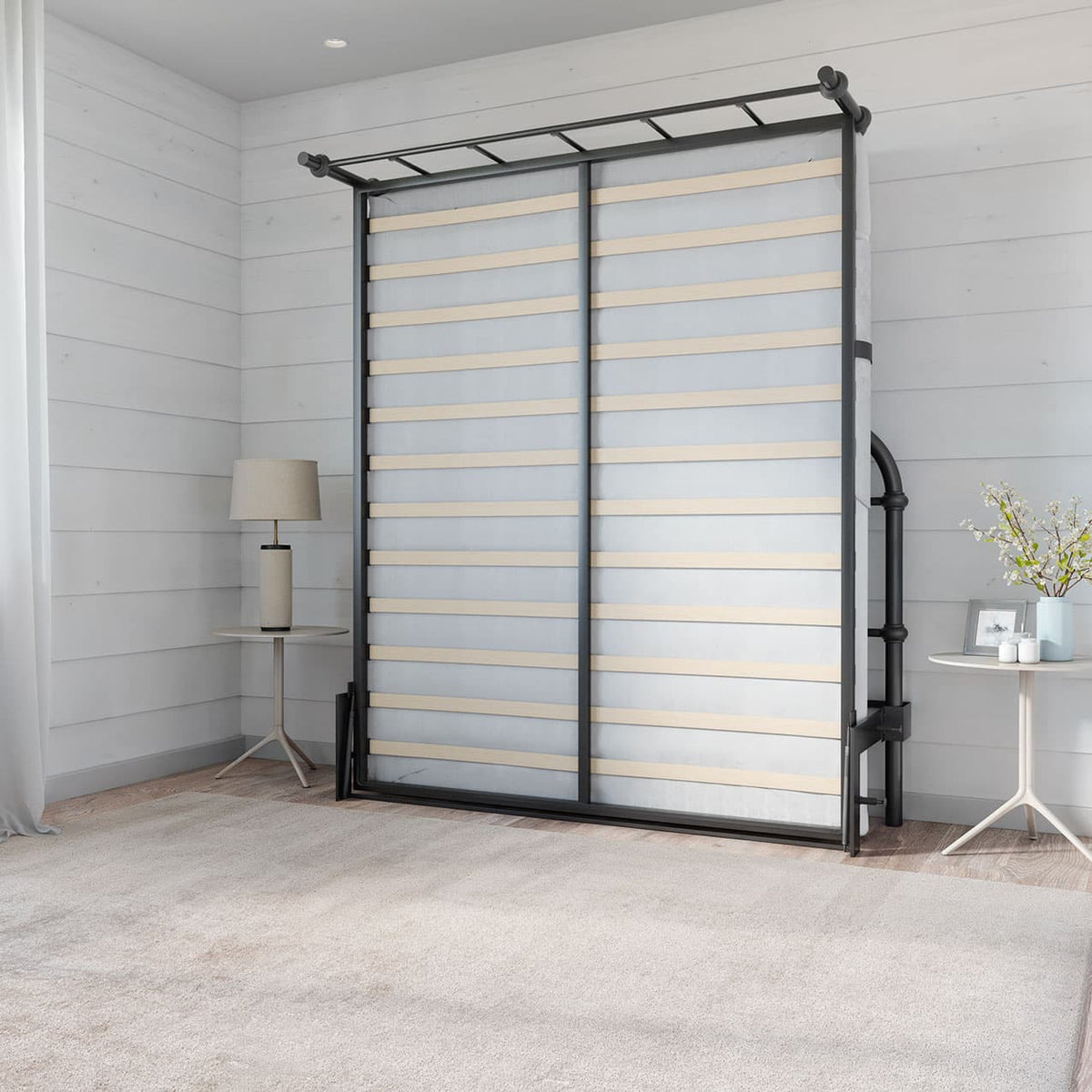 room with a black metal liftable bed up against the wall with two small side tables and a carpet