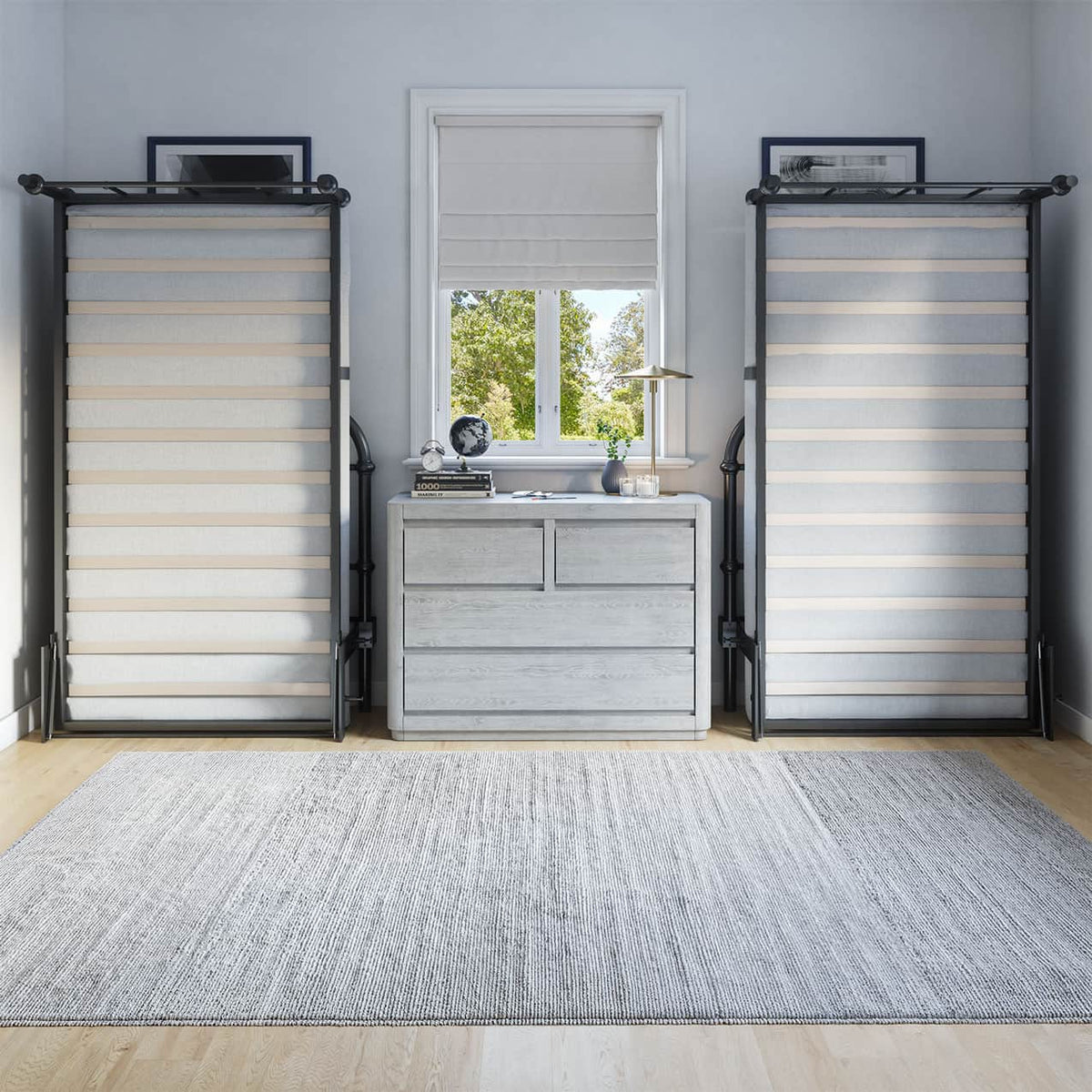 Room with gray walls, a window with blinds, and two black metal twin beds lifted up against the wall.