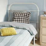 Bed with striped bedding and checkered pillow, wooden nightstand in a bedroom.
bed frame with headboard footboard lift bed storage lift up bedroom furniture risers space-saving black metal 