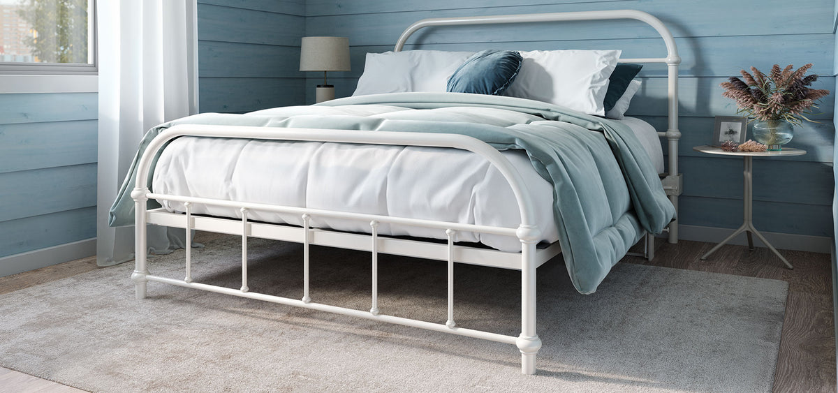 White metal bed in a styled bedroom setting. The RoomBed can lift to 90 degrees to give you access to the space under the bed. 